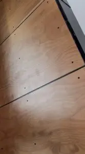 Close-up view of wooden panels fastened with visible black screws and separated by thin black lines, showcasing the sleek attention to detail found in Bellevue Meydenbauer custom home design.